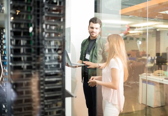 Colleagues discussing in office server room